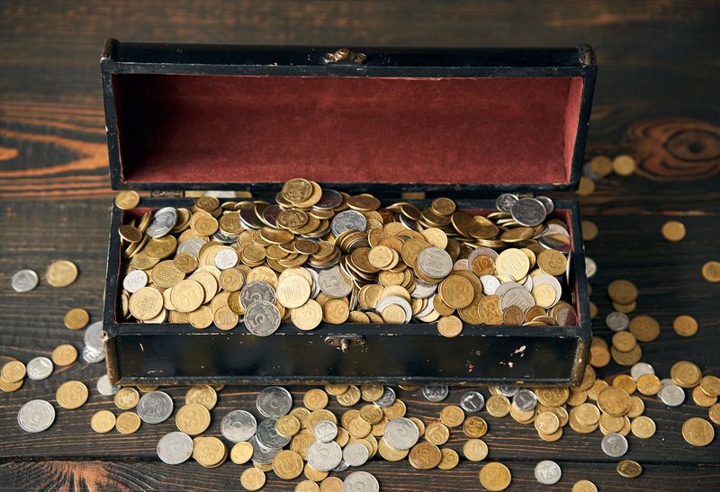 Wooden chest of old gold and silver world coins sorted at a Dallas appointment