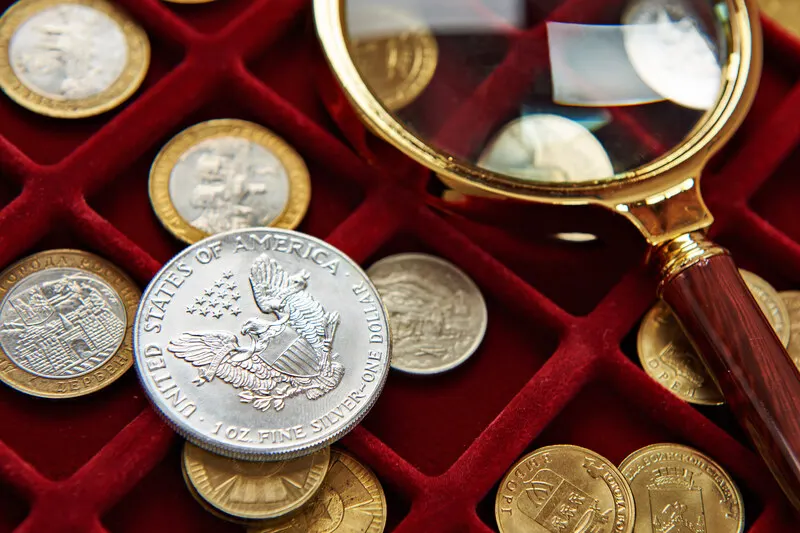 Silver dollar inspected with a magnifying loupe